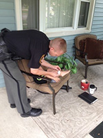man writing outside a house